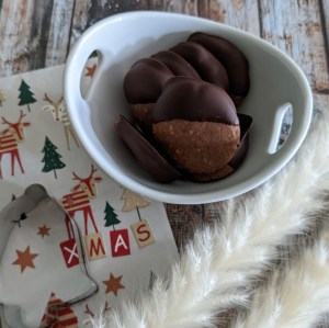 Schokoladen-Plätzchen in einer kleinen Schale, der Tisch ist weihnachtlich geschmückt